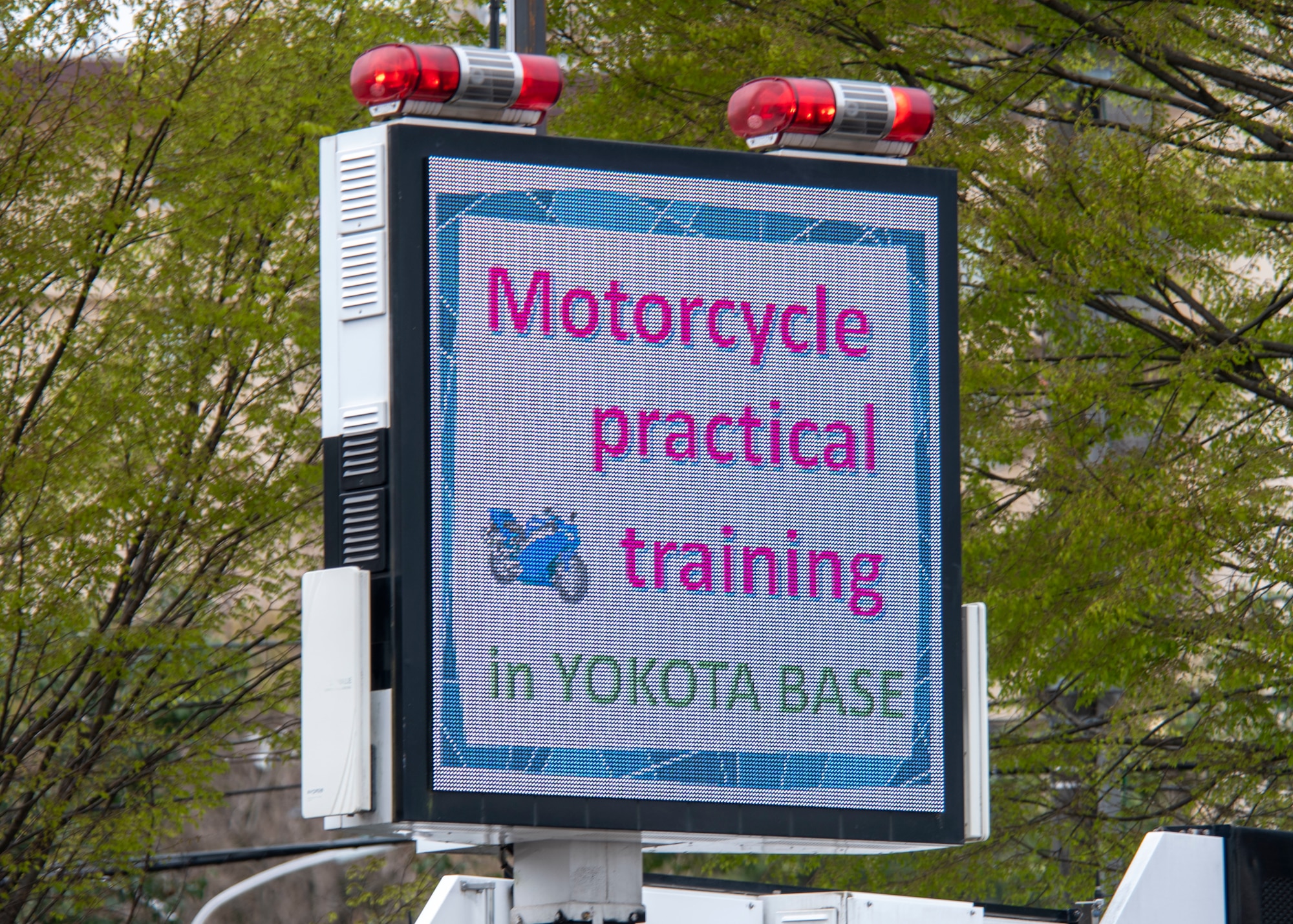 an illuminated sign displaying a motorcycle event