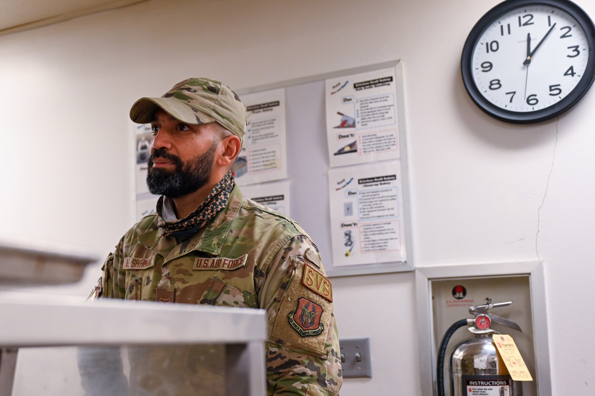 Air Force Airman 1st Class Riyadh Al-Shihmani, a 934th Force Support Squadron services specialist, watches the lunch line dwindle down at the Community Activity Center in Minneapolis-St. Paul Air Reserve Station, Minnesota, April 1, 2023. Al-Shihmani was originally from Iraq, and it was his dream to come to America and join the U.S. military. (U.S. Air Force photo by Senior Airman Matthew Reisdorf)