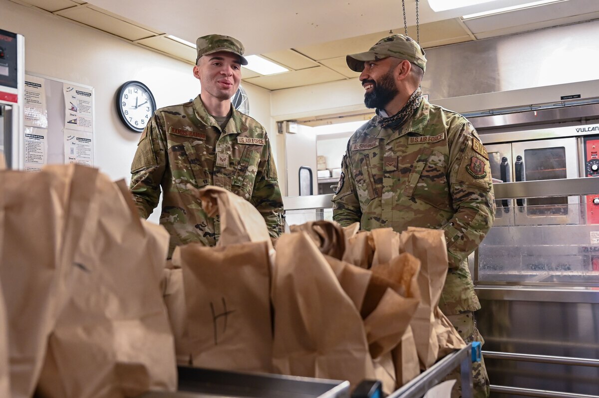 Airman 1st Class Riyadh Al-Shihmani, right, and Senior Airman Frankie Ramos-Ramos, both 934th Force Support Squadron services specialists, pack lunches at the Community Activity Center in Minneapolis-St. Paul Air Reserve Station, Minnesota, April 1, 2023. Al-Shihmani is originally from Iraq, and it was his dream to come to America and join the U.S. military. (U.S. Air Force photo by Senior Airman Matthew Reisdorf)