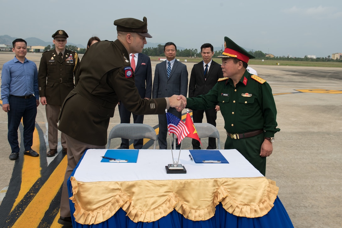 U.S. Army Lt. Col. Travis Walter, Defense POW/MIA Accounting Agency (DPAA) Detachment 2 Commander, and General Nguyễn Bá Thắng, Vietnamese Office for Seeking Missing Persons (VNOSMP), shake hands before a repatriation ceremony, Da Nang, Socialist Republic of Vietnam, April 10, 2023. The ceremony marked the culmination of the efforts of two recovery teams and one investigative team to recover service members unaccounted for during the Vietnam War. During the ceremony, the honor guard team escorted the potential osseous material for transport to the DPAA Laboratory in Joint Base Pearl Harbor Hickam, Hawaii. Once there, the scientific analysis process will begin. There are currently 1,579 Americans missing from the Vietnam War. (U.S. Air Force photo by Senior Airman Cole Yardley)