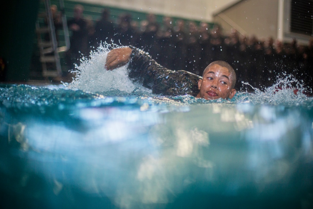 A Marine Corp recruit swims in a pool.