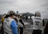 TYRRHENIAN SEA (March 22, 2023) Natasha Franceschi, U.S. deputy chief of mission, U.S. Embassy Tunis, watches F/A-18 Super Hornet aircraft launch from the flight deck of the Nimitz-class aircraft carrier USS George H.W. Bush (CVN 77), March 22, 2023. Carrier Air Wing (CVW) 7 is the offensive air and strike component of Carrier Strike Group (CSG) 10 and the George H.W. Bush CSG. The squadrons of CVW-7 are Strike Fighter Squadron (VFA) 143, VFA-103, VFA-86, VFA-136, Carrier Airborne Early Warning Squadron (VAW) 121, Electronic Attack Squadron (VAQ) 140, Helicopter Sea Combat Squadron (HSC) 5, and Helicopter Maritime Strike Squadron (HSM) 46. The George H.W. Bush CSG is on a scheduled deployment in the U.S. Naval Forces Europe area of operations, employed by U.S. Sixth Fleet to defend U.S., allied and partner interests.