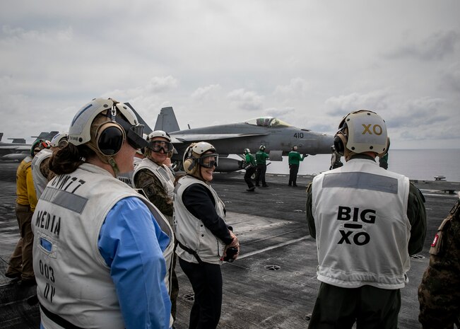 TYRRHENIAN SEA (March 22, 2023) Natasha Franceschi, U.S. deputy chief of mission, U.S. Embassy Tunis, watches F/A-18 Super Hornet aircraft launch from the flight deck of the Nimitz-class aircraft carrier USS George H.W. Bush (CVN 77), March 22, 2023. Carrier Air Wing (CVW) 7 is the offensive air and strike component of Carrier Strike Group (CSG) 10 and the George H.W. Bush CSG. The squadrons of CVW-7 are Strike Fighter Squadron (VFA) 143, VFA-103, VFA-86, VFA-136, Carrier Airborne Early Warning Squadron (VAW) 121, Electronic Attack Squadron (VAQ) 140, Helicopter Sea Combat Squadron (HSC) 5, and Helicopter Maritime Strike Squadron (HSM) 46. The George H.W. Bush CSG is on a scheduled deployment in the U.S. Naval Forces Europe area of operations, employed by U.S. Sixth Fleet to defend U.S., allied and partner interests.