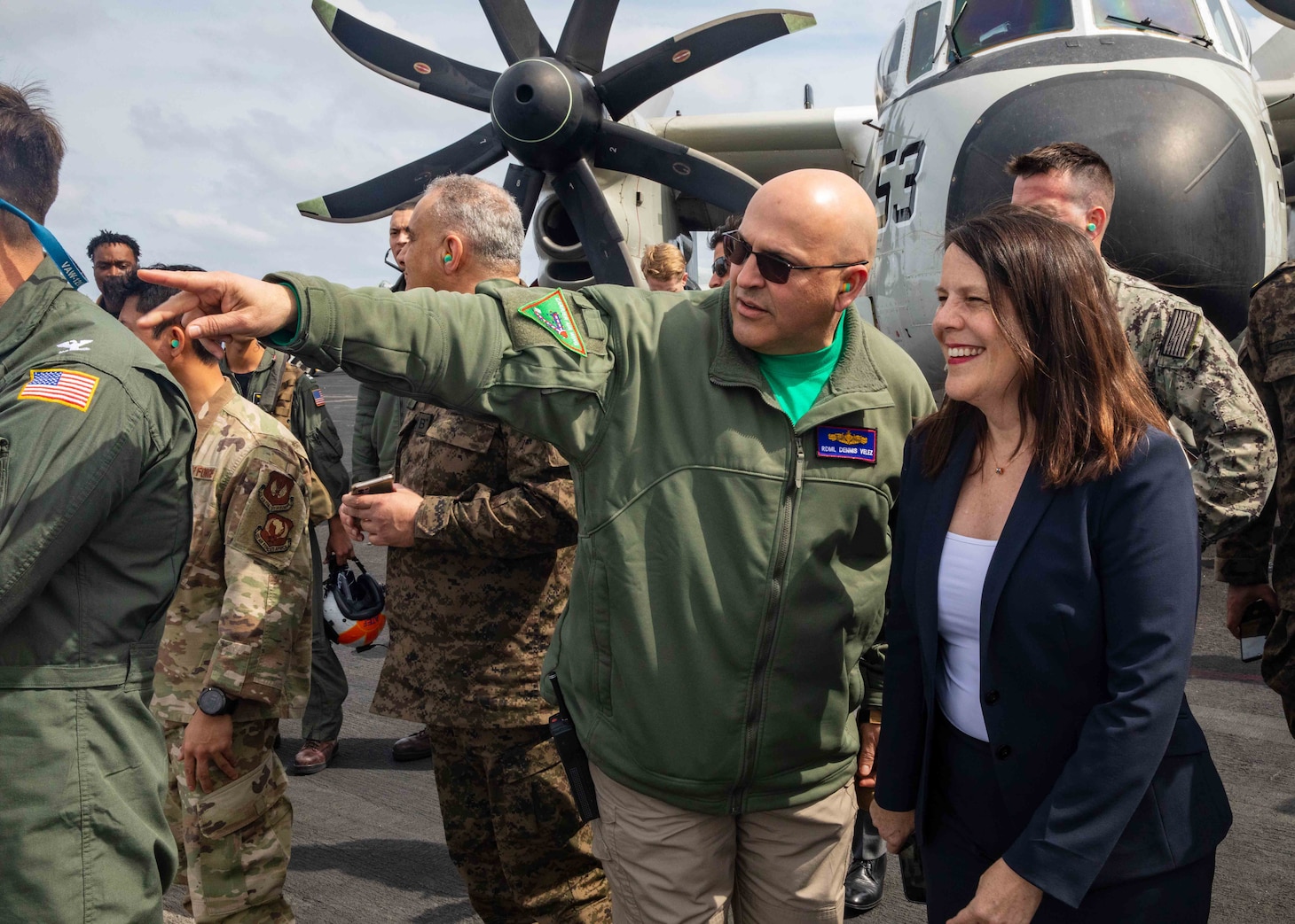 TYRRHENIAN SEA (March 22, 2023) Rear Adm. Dennis Velez, left, commander, Carrier Strike Group (CSG) 10, George H.W. Bush Carrier Strike Group, and Natasha Franceschi, U.S. Deputy Chief of Mission, U.S. Embassy Tunis observe the Electronic Attack Squadron (VAQ) 140 change of command ceremony during a key leader engagement aboard the Nimitz-class aircraft carrier USS George H.W. Bush (CVN 77), March 22, 2023. The George H.W. Bush Carrier Strike Group is on a scheduled deployment in the U.S. Naval Forces Europe area of operations, employed by U.S. Sixth Fleet to defend U.S., allied, and partner interests.