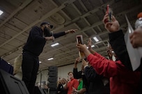 TYRRHENIAN SEA (March 25, 2023) Blanco Brown, performing artist, performs for Sailors aboard the Nimitz-class aircraft carrier USS George H.W. Bush (CVN 77) during a USO concert in the hangar bay, March 25, 2023. The George H.W. Bush Carrier Strike Group is on a scheduled deployment in the U.S. Naval Forces Europe area of operations, employed by U.S. Sixth Fleet to defend U.S., allied and partner interests.