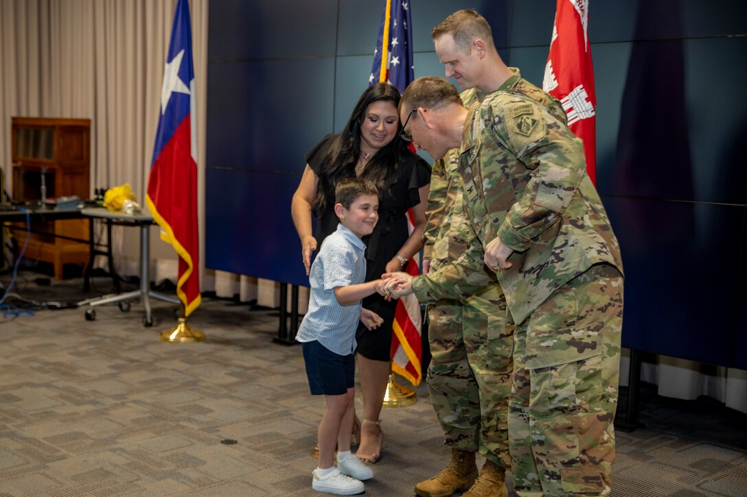 Son of U.S. Army Corps of Engineers Galveston District Deputy Commander for Mega Projects Lt. Col. Ian O’Sullivan shakes hands with District Commander Col. Rhett Blackmon during Lt. Col O’Sullivan’s promotion ceremony at the district headquarters.