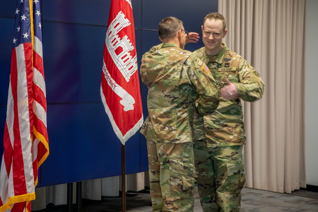 U.S. Army Corps of Engineers Galveston District Deputy Commander for Mega Projects Lt. Col. Ian O’Sullivan, right, shakes hands and embraces District Commander Col. Rhett Blackmon during Lt. Col O’Sullivan’s promotion ceremony at the district headquarters.