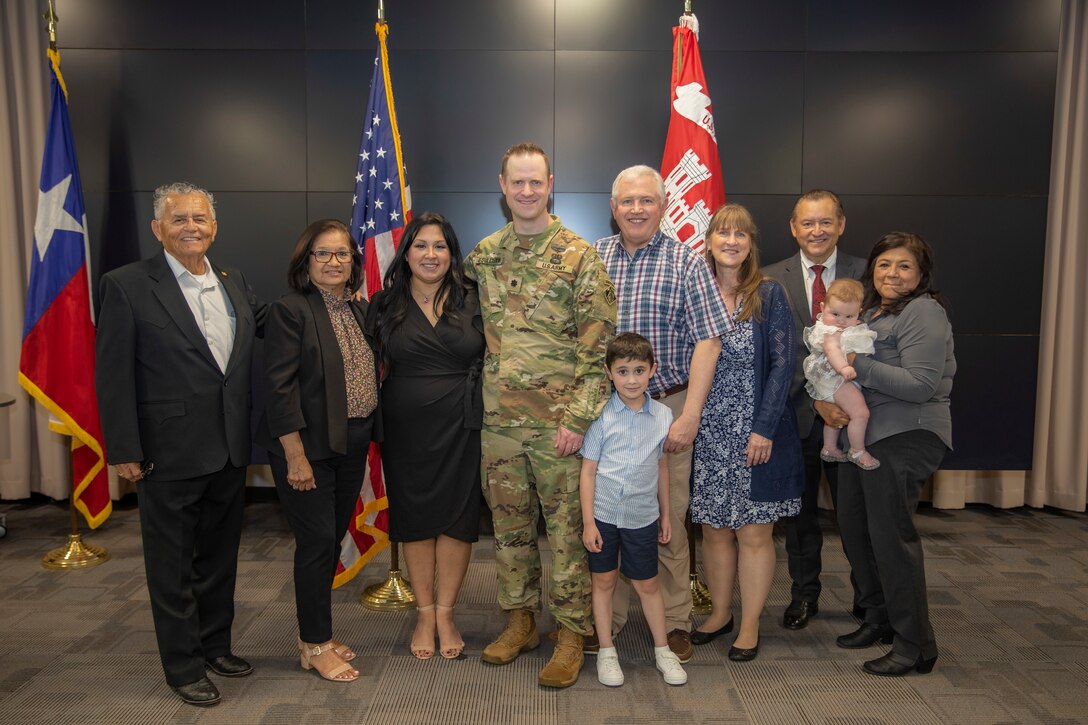 U.S. Army Corps of Engineers Galveston District Deputy Commander for Mega Projects Lt. Col. Ian O’Sullivan, fourth from left, takes a picture with his family after his promotion ceremony at the district headquarters.
