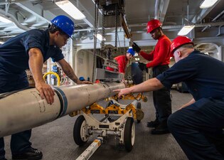 Sailors move a missile aboard USS George H.W. Bush (CVN 77).