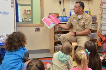 Capt. Terrence Shashaty reads to a class at the NAS Pensacola Child Development Center.