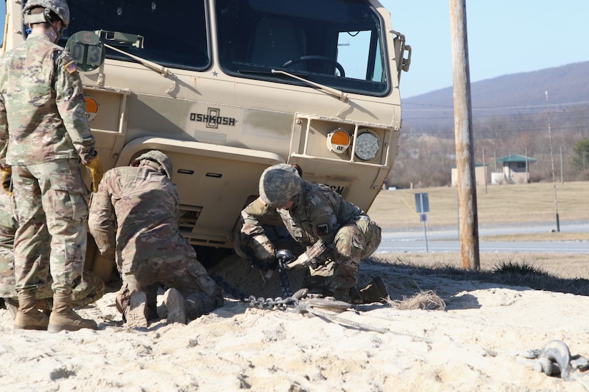 Spc. Kelsey Akers and her group prepare a Light Medium Tactical Vehicle (LMTV)to be pulled out of the Mire Pit, as a part of the recovery portion of the H8 course.
The 80th Training Command’s Regional Training Maintenance Site Fort Indian Town Gap graduated its most recent class of Wheeled Recovery Specialists, also known by the designation H8 (pronounced as “Hotel-8”).