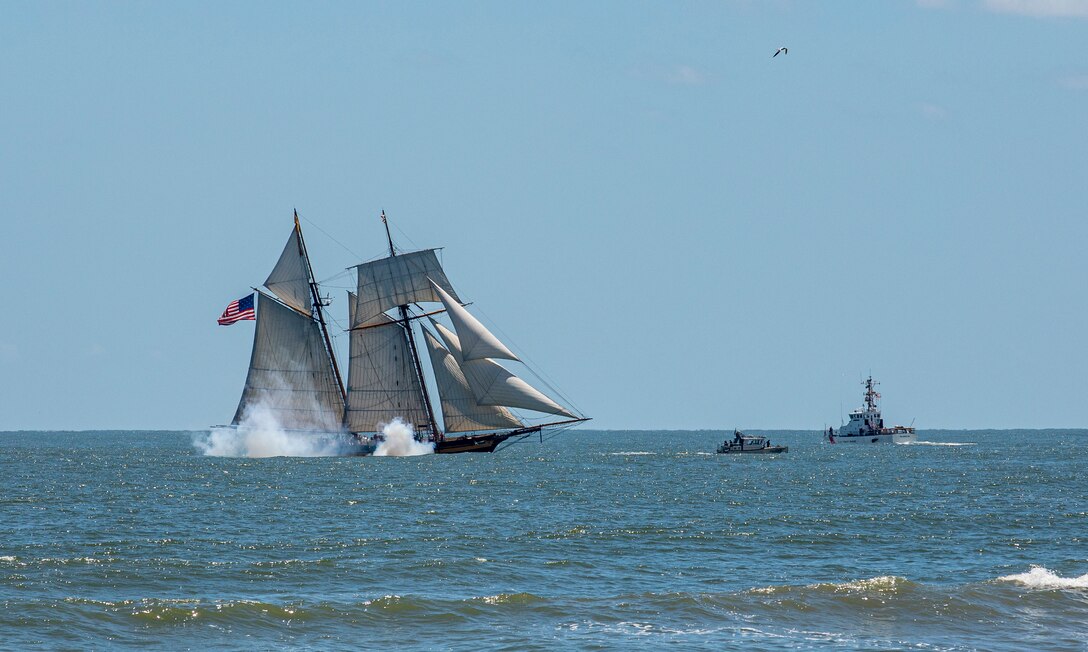 Pride of Baltimore 2, a square-topsail schooner and reconstruction of an early 19th-century Baltimore Clipper, fires her cannons as she transits the Gulf of Mexico off the coast of Galveston Beach during Tall Ships Challenge Galveston 2023.