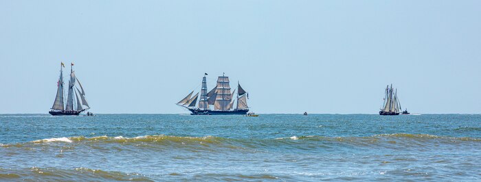 Ernestina-Morrissey, a grand banks fishing schooner and last fishing schooner built for the Wonson Fish Company, left, Pride of Baltimore 2, a square-topsail schooner and reconstruction of an early 19th-century Baltimore Clipper, middle, and Elissa, a three-masted barque and one of three ships of her kind still active, transit the Gulf of Mexico off the coast of Galveston Beach during Tall Ships Challenge Galveston 2023.