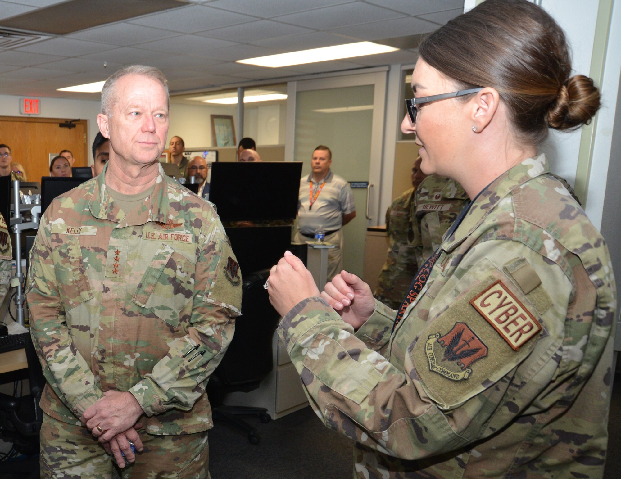 U.S. Air force Lt. Col. Mica Myers, 690th Intel Support Squadron commander, provides a mission update to Gen. Mark Kelly, commander of Air Combat Command, April 12, 2023, during his visit to Joint Base San Antonio-Lackland, Texas.