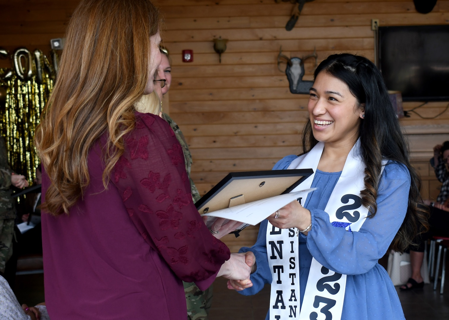 Lexie Morin, a graduate of the American Red Cross Dental Assistant training program and native of Houston, receives her certificate of completion during a graduation for dental assistant students at the Sportsman Lounge on Fort Drum, N.Y., April 6, 2023.