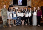 Students of the American Red Cross Dental Assistant training program stand with their certificates of completion during the program’s graduation ceremony at the Sportsman Lounge on Fort Drum, N.Y., April 6, 2023.