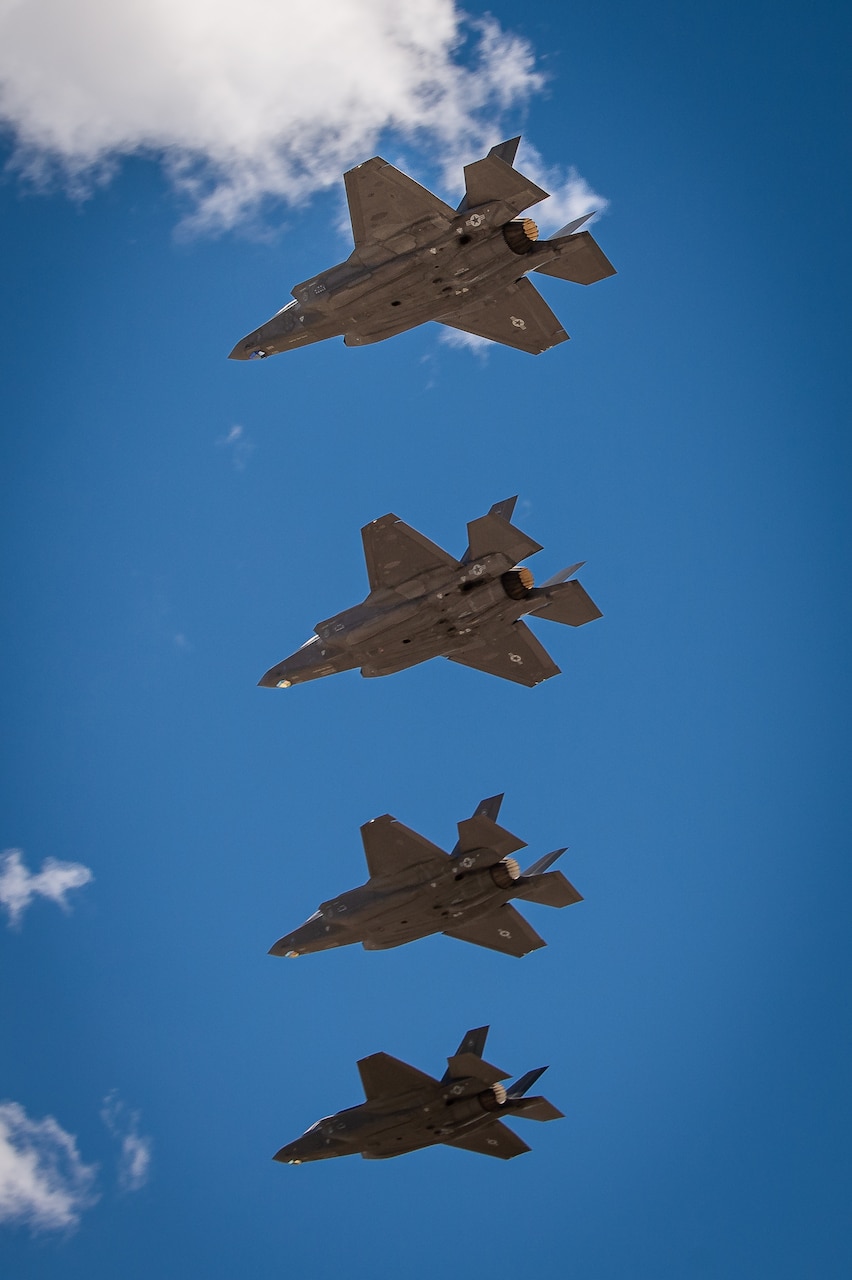 Four aircraft fly in formation.