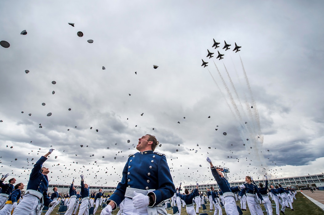 U.S. Air Force Academy Class of 2020 graduates toss their hats in the air as the Air Force Thunderbirds flyover