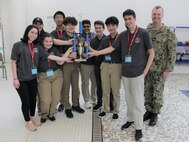 Naval Surface Warfare Center, Philadelphia Division (NSWCPD) Commanding Officer Capt. Joseph Darcy awards Haddonfield High School with the Overall Best award in the Captain’s Class during the 18th annual Greater Philadelphia SeaPerch Challenge at The Salvation Army Ray & Joan Kroc Center in Philadelphia on March 24, 2023. SeaPerch is an international underwater robotics competition for middle and high school students. (U.S. Navy photo by Sgt. Jermaine Sullivan/Released)