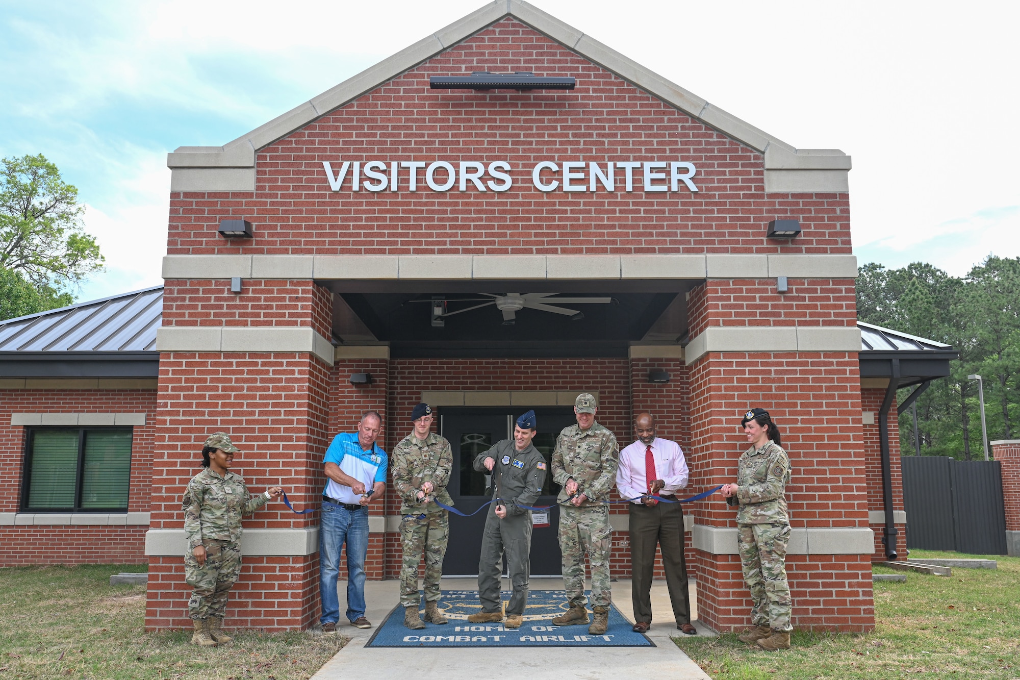 Members cut the ribbon during ribbon-cutting ceremony.