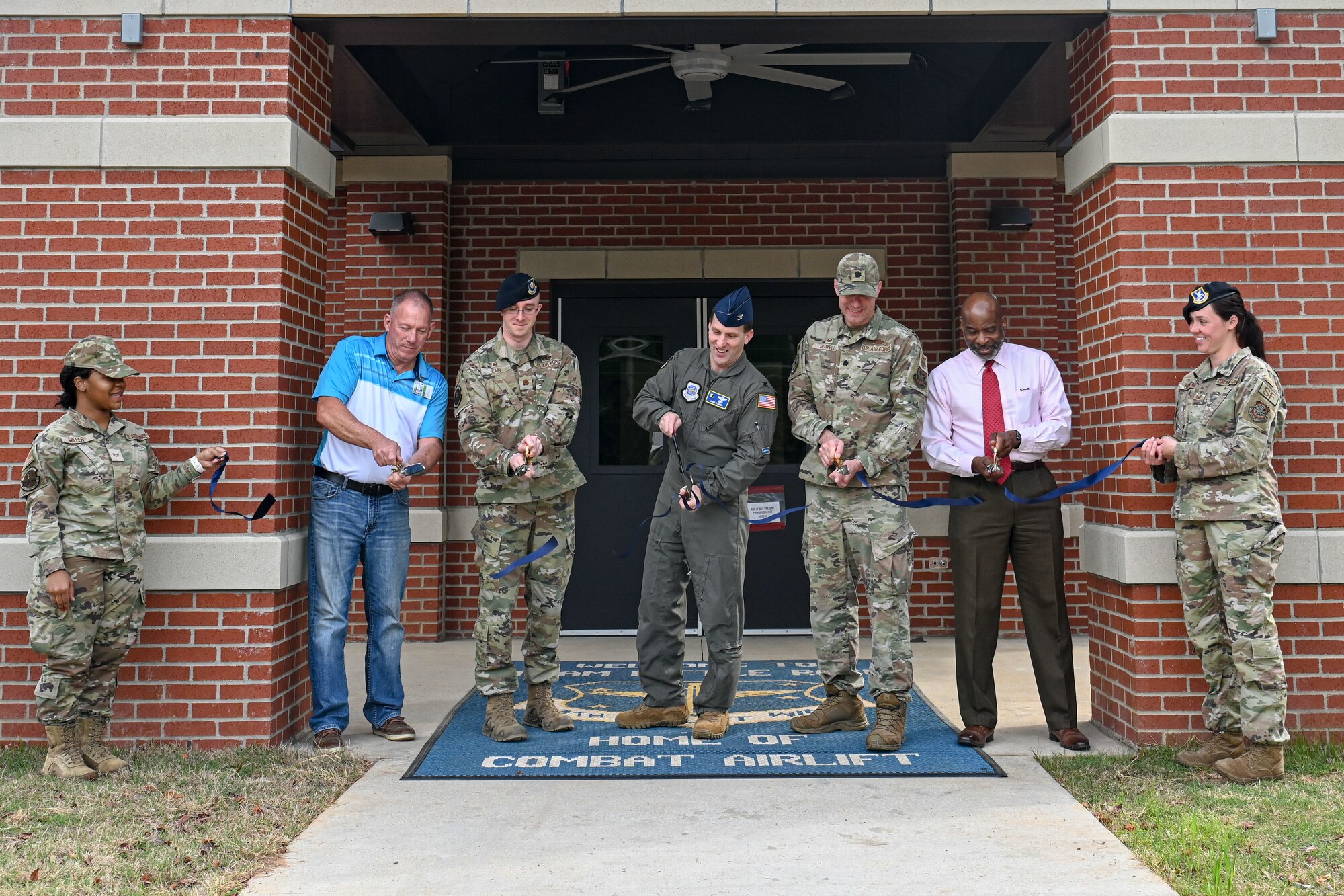 Members cut the ribbon during ribbon-cutting ceremony.