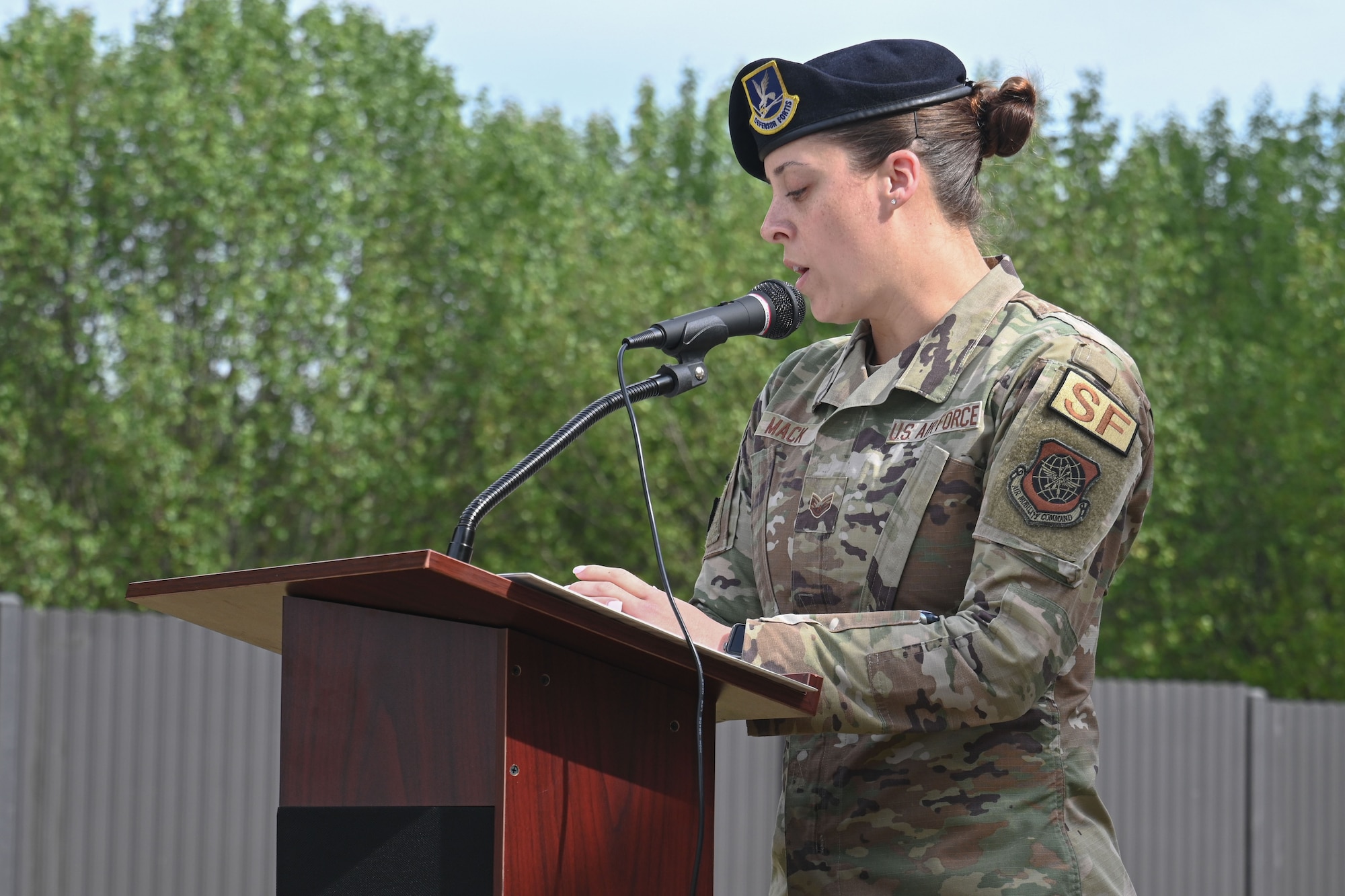 woman in uniform speaks during ribbon-cutting ceremony.
