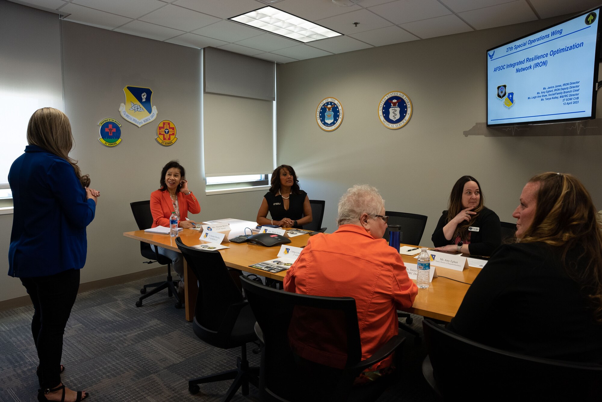 A group of people are gathered to discuss resources available to Airmen and their families at Cannon Air Force Base, N.M.