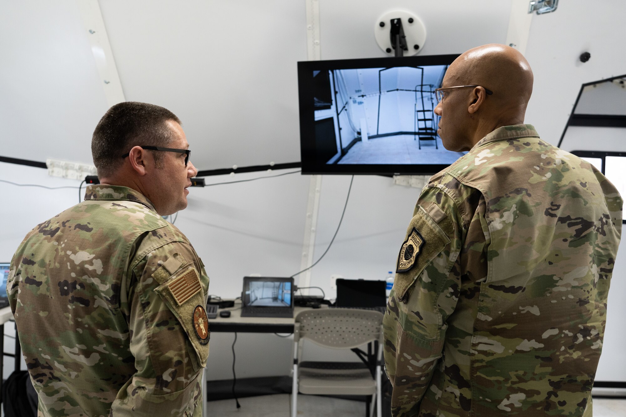 Two Airmen are talking to each other about the repair back shop known as the Advanced Deployable Aircraft Maintenance System.