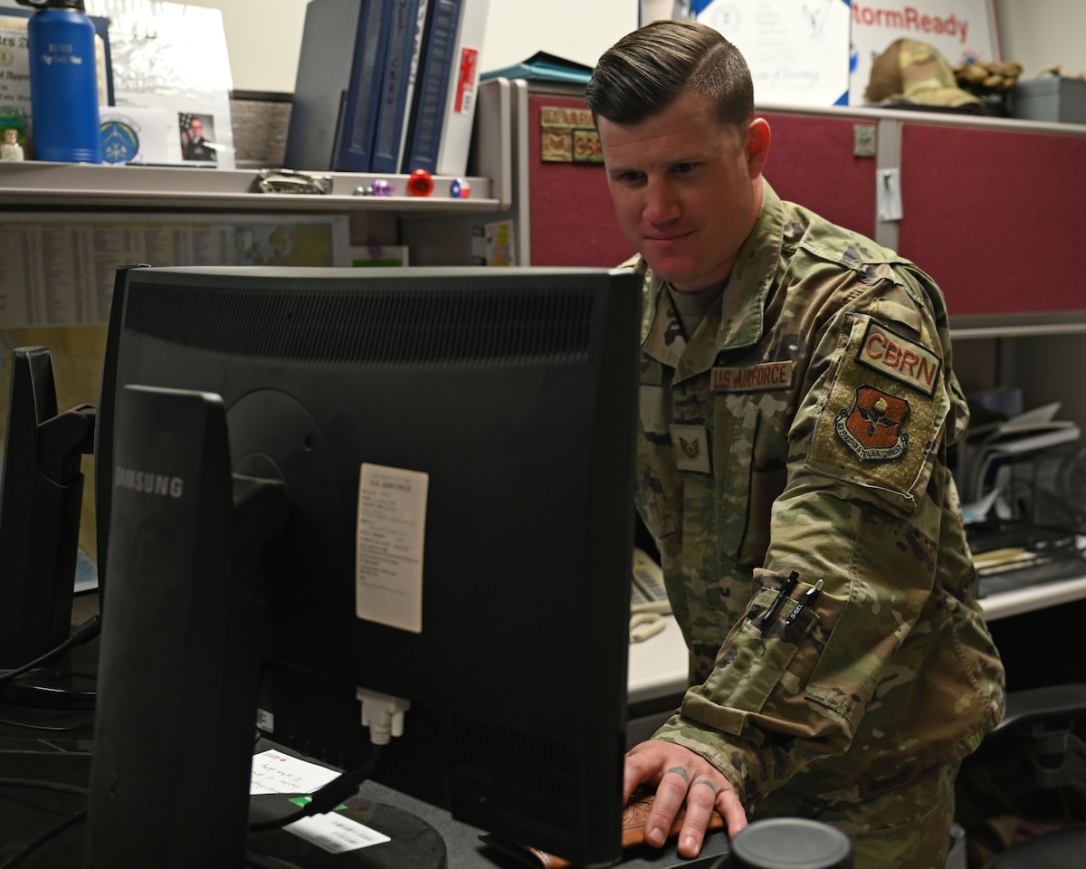 U.S. Air Force Tech. Sgt. Cody West, 17th Civil Engineer Squadron emergency management Non-Commissioned Officer in Charge, works at his desk at Goodfellow Air Force Base, Texas, April 3, 2023. Emergency Management professionals develop plans to ensure all other Air Force personnel are trained to meet mission needs and to minimize casualties and damage in the event of any disaster situation. (U.S. Air Force photo by Airman 1st Class Zachary Heimbuch)