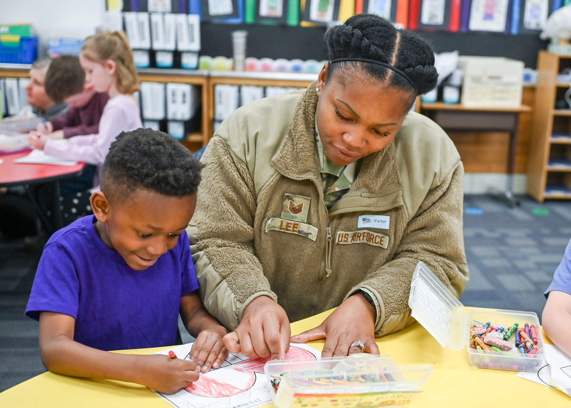 Technical Sgt. Shannon Lee, 75th Medical Group, and her son David, color together April 14, 2023