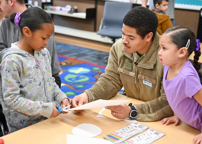 Senior Airman Alexander Ross, 388th Munitions Squadron, and daughters Giavanina and Ailah, craft together