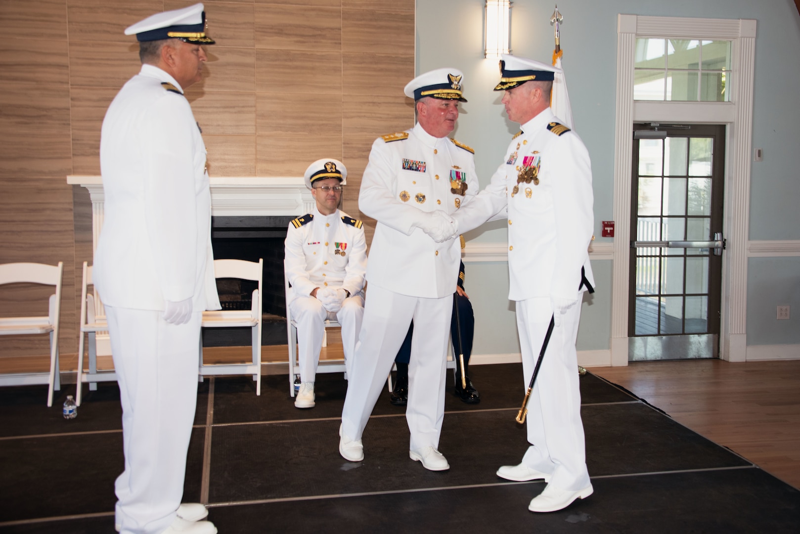 Capt. Francis J. DelRosso, Coast Guard Sector Jacksonville commander, Rear Adm. Brendan C. McPherson, Coast Guard Seventh District Commander, and Capt. John D. Cole, former Sector Charleston commander, conducts a change-of-command ceremony at The Citadel Beach Club, Charleston, South Carolina, April 14, 2023. Capt. DelRosso relieves Capt. Cole of command. (U.S. Coast Guard photo by Petty Officer 1st Class David Micallef)
