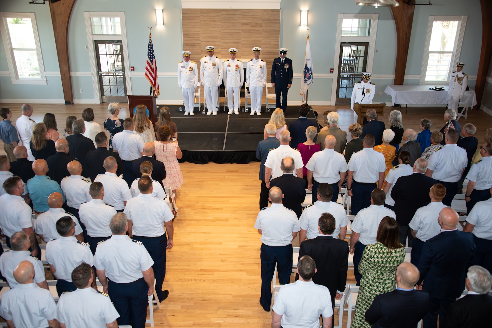 During a change of command ceremony, all stand for the presentation of the colors in Charleston, South Carolina, April 14, 2023. A change of command ceremony is a time-honored tradition formally restating the continuity of the authority of command. It is a transfer of total responsibility and authority from one individual to another. (U.S. Coast Guard photo by Petty Officer 1st Class David Micallef)