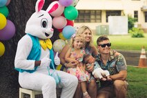 A family poses with a mascot for a photo during the Headquarters Battalion Spring Egg-stravaganza, Marine Corps Base Hawaii, April 7, 2023. The event was held to provide Marines, Sailors, and their families with an opportunity to participate in spring activities. (U.S. Marine Corps photo by Cpl. Brandon Aultman)