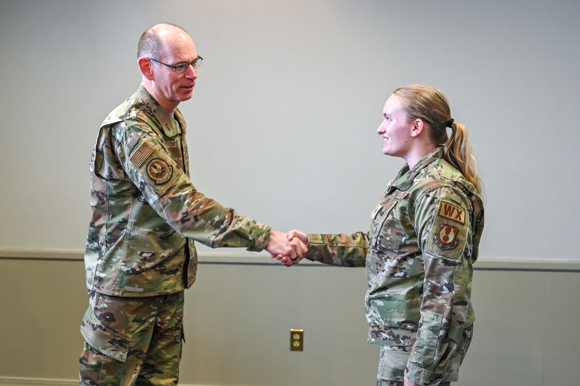 Gen. Duke Z. Richardson, Air Force Materiel Command commander, coins Staff Sgt. Kathryn King, 75th Operations Support Squadron, for outstanding performance during a base visit April 13, 2023, at Hill Air Force Base, Utah