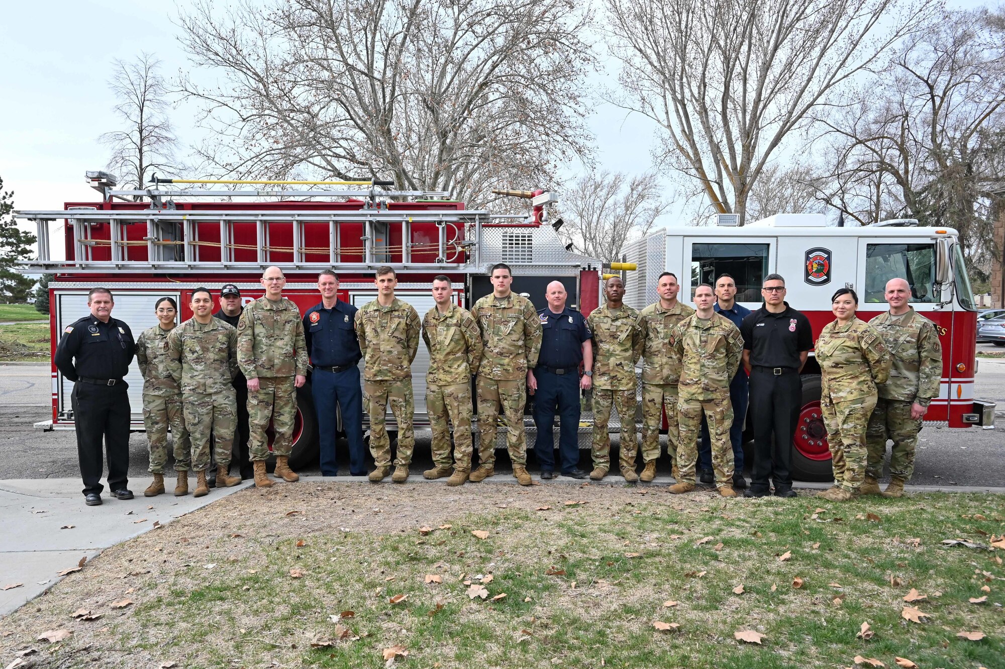 Gen. Duke Z. Richardson, Air Force Materiel Command commander, and Chief Master Sgt. David A. Flosi, AFMC command chief, gather with members of the 775th Civil Engineer Squadron Fire and Emergency Services in front of a fire truck