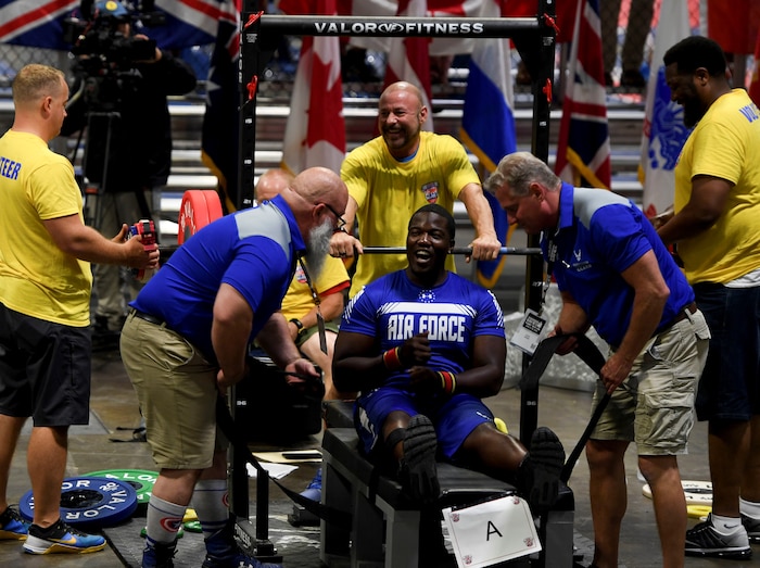 Image of Staff Sgt. DeMarcus Garrett celebrating after completing his bench press.
