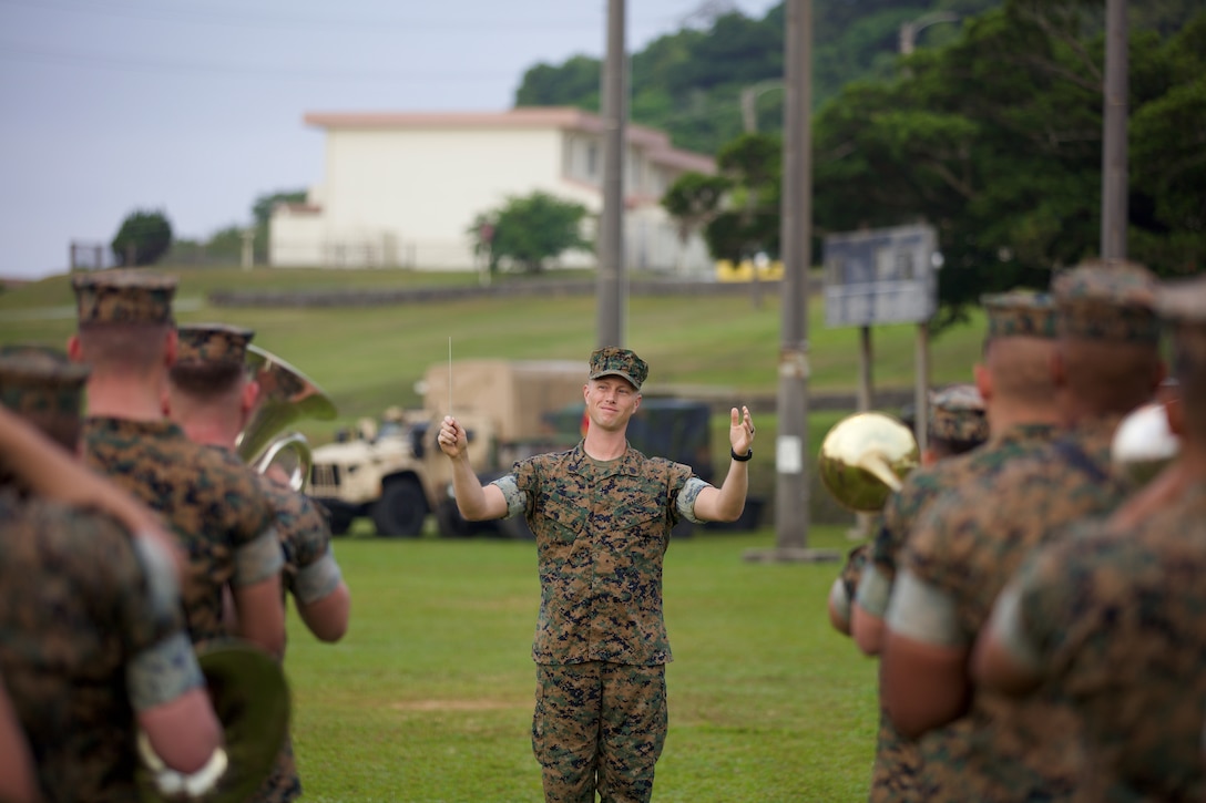 U.S. Marine Staff Sergeant Michael Barnett conducts the III Marine Expeditionary Force Band during the 3d Marine Division Relief and Appointment and Change of Charge Ceremony on Camp Courtney.