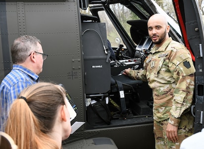 U.S. Army Warrant Officer Dejour Hughes, a UH-60 Black Hawk helicopter pilot with the 28th Expeditionary Combat Aviation Brigade, demonstrates cockpit instruments to first responders at the Covington Independent Fire Company, Covington, Pennsylvania, April 15, 2023. Civil-military outreach engagements promote stronger relationships with first responders.