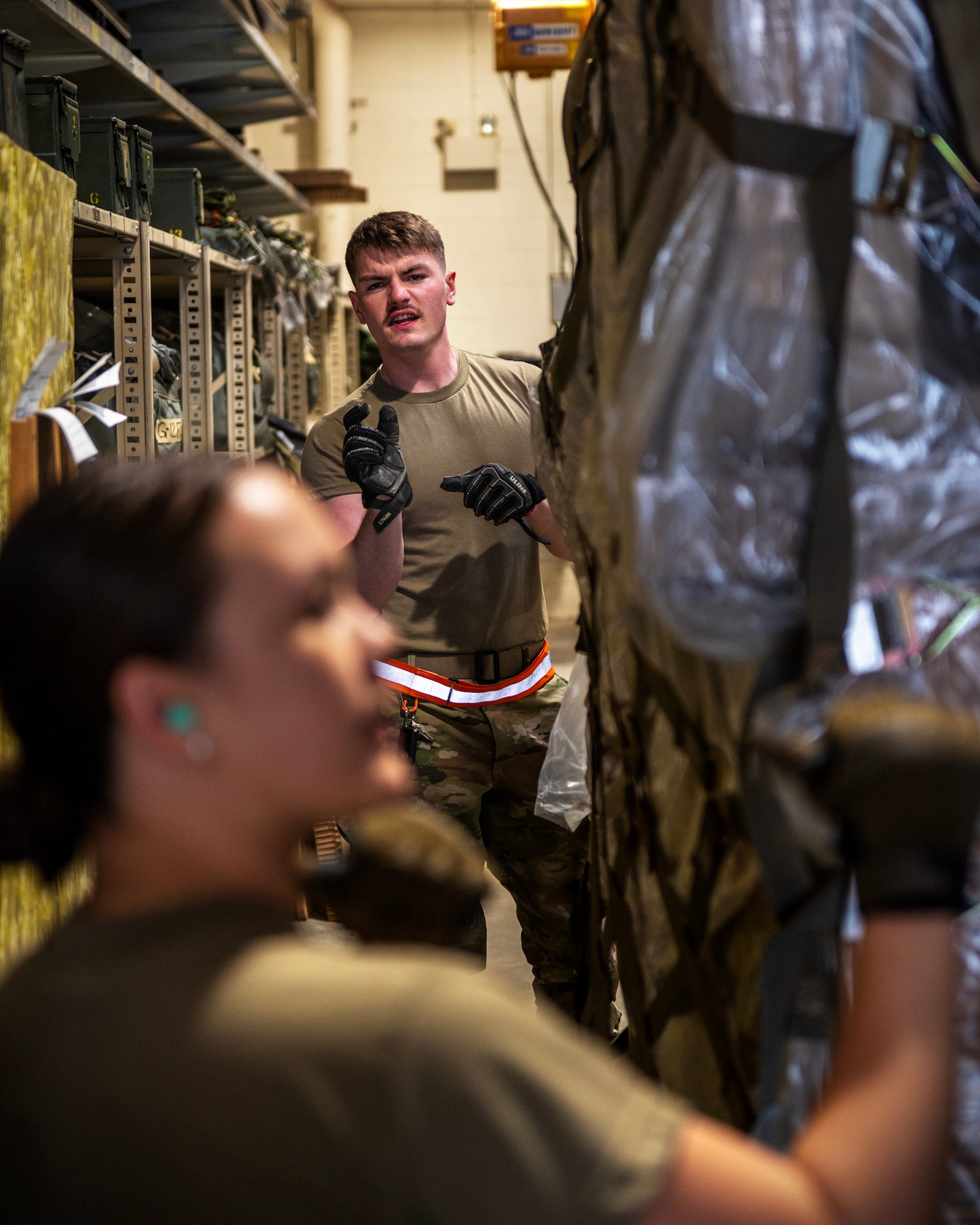 U.S. Air Force Senior Airman Jack Hyland, from the 133rd Air Transportation Function, helps guide  a pallet containing humanitarian supplies in St. Paul, April 16, 2023.