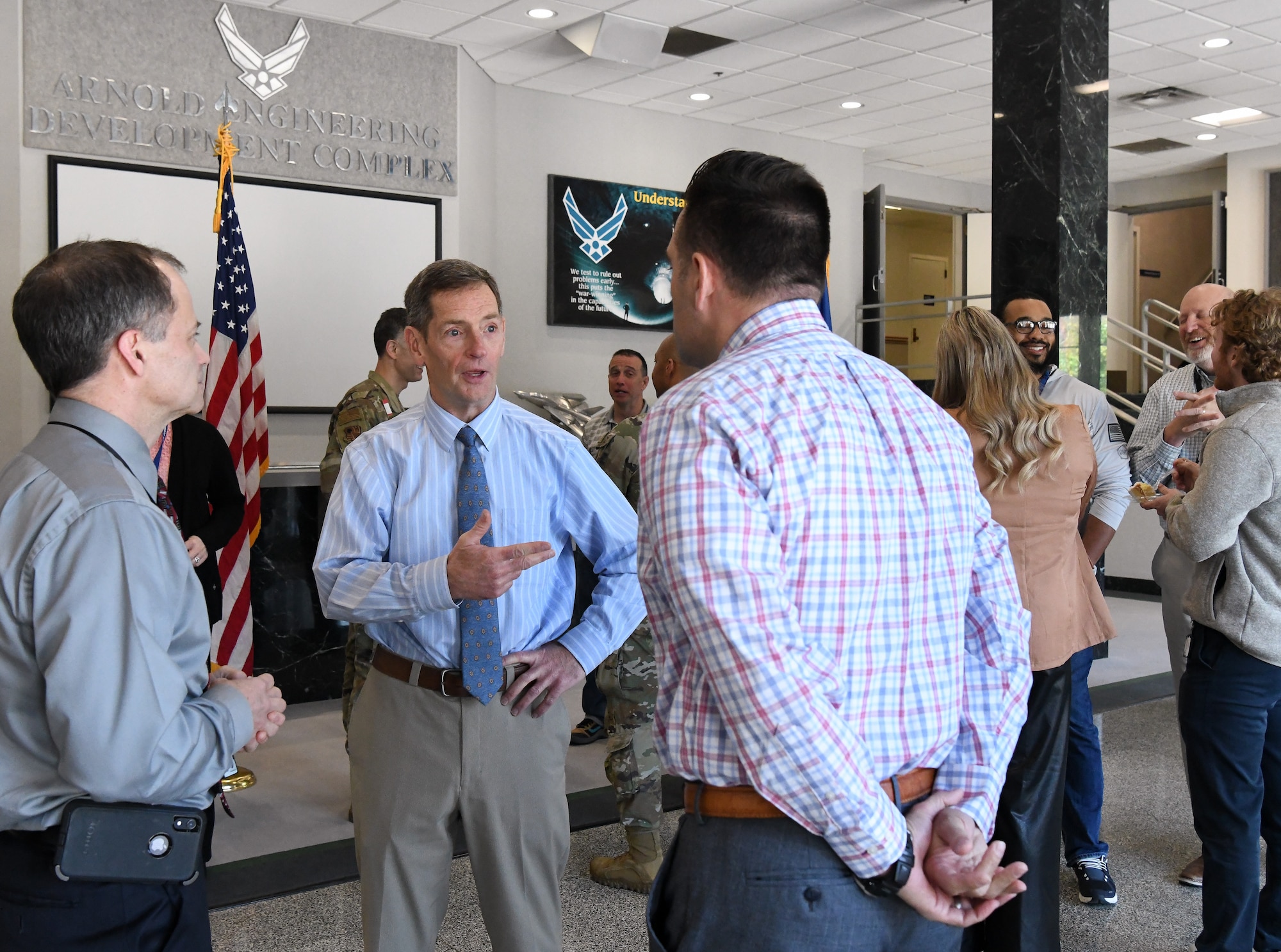 Kevin Muckerheide, center, the new vice director of Arnold Engineering Development Complex, speaks with AEDC team members Ed Tucker, left, and Brandon Lucy during a welcome reception for Muckerheide at Arnold Air Force Base, Tenn., April 12, 2023. (U.S. Air Force photo by Jill Pickett)
