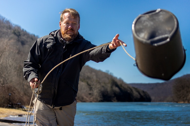 Carl Nim, a biologist with U.S. Army Corps of Engineers Pittsburgh District’s Water Quality team, collects a water sample from the outflow at Kinzua Dam in Warren, Pennsylvania, March 30, 2023. The district’s Water Quality team collected water samples from the Allegheny River both before and after the spring pulse to compare the pulse’s effect along various points on the river. The collected samples are sent to the Corps of Engineers Research and Development Center to test and analyze myriad factors such as pH acidity, alkalinity, metals, nutrients, and conductivity. (U.S. Army Corps of Engineers Pittsburgh District photo by Andrew Byrne)