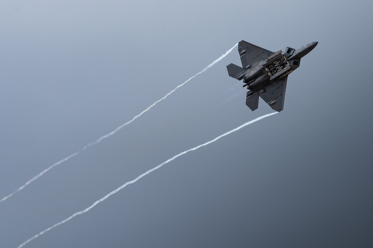 An aircraft flies up in front of clouds.