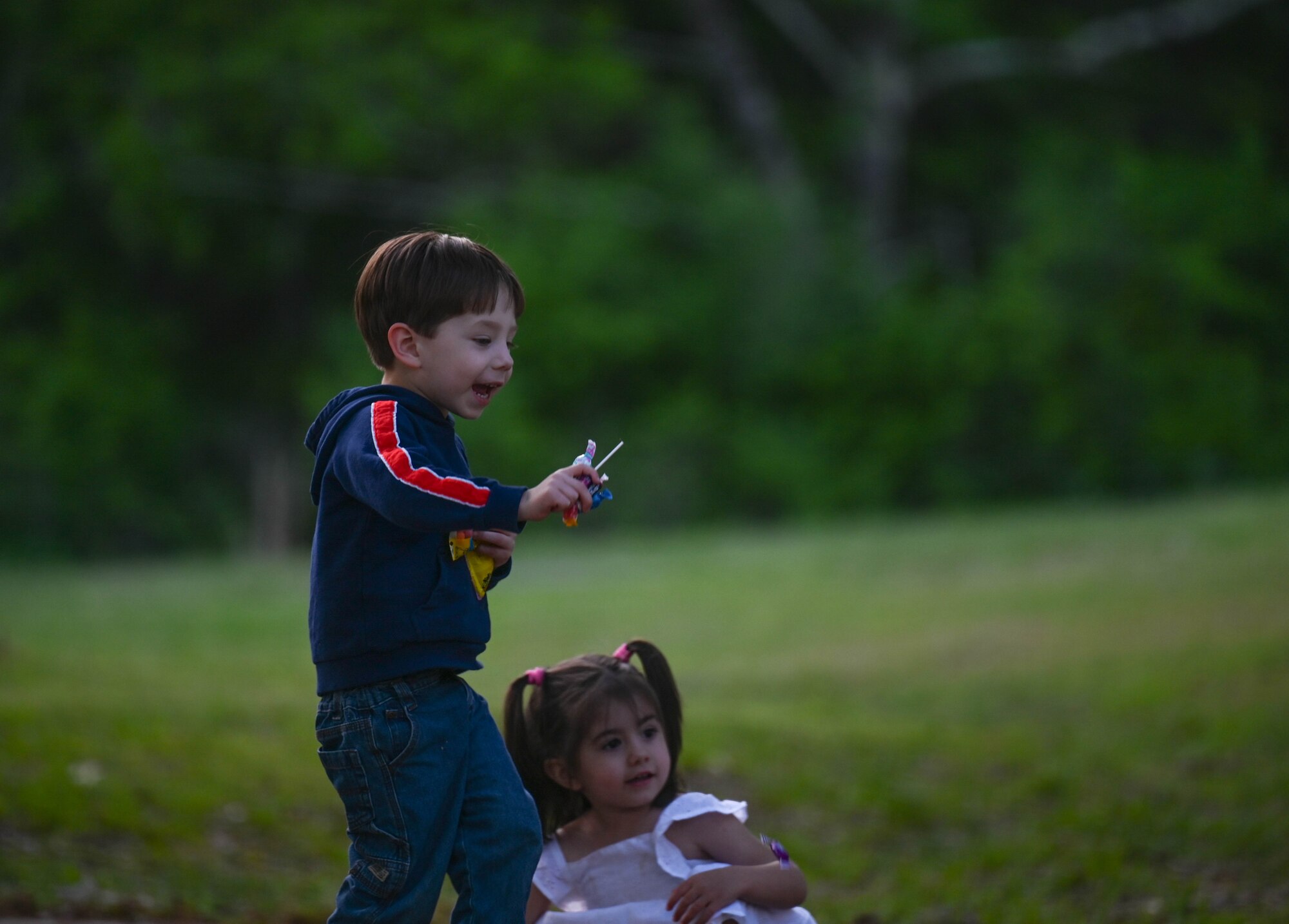 Children smile with candy in their hands.