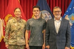(L to R) Col. Megan Stallings, commander, USMEPCOM, Carter Stallings, Air Force recruit, and Chris Stallings, executive director, Naval Service Training Command, pose for a photo at Chicago MEPS moments before Carter ships to Basic Military Training.