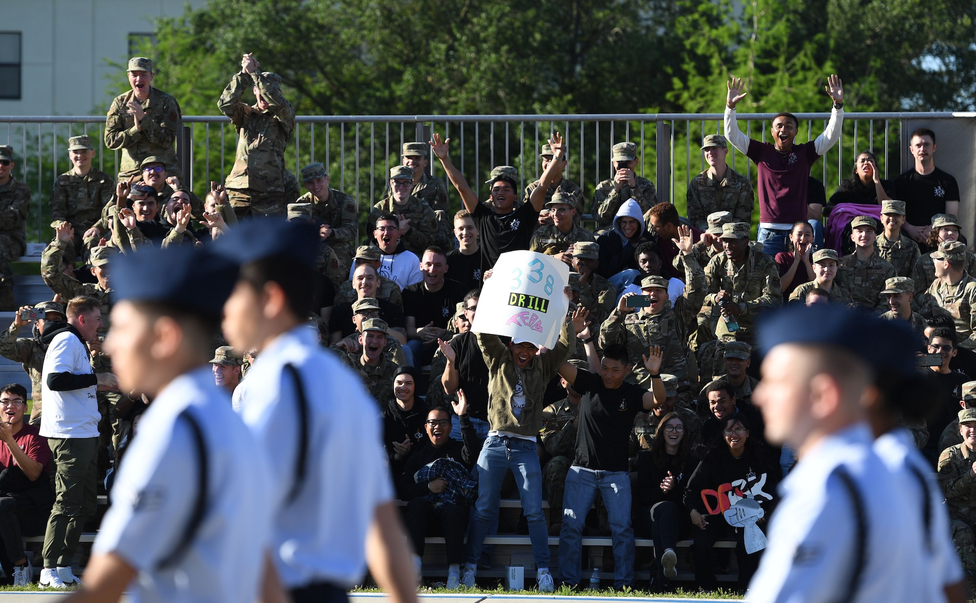 Members of the 338th Training Squadron cheer during the 81st Training Group drill down on the Levitow Training Support Facility drill pad at Keesler Air Force Base, Mississippi, April 14, 2023.