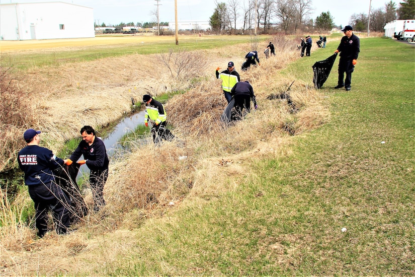 People clean up a field.