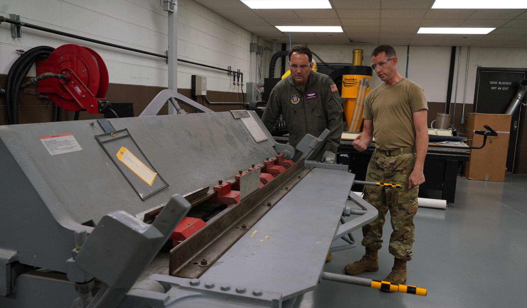 Master Sgt. explains how to read the angles when bending the sheet metal.