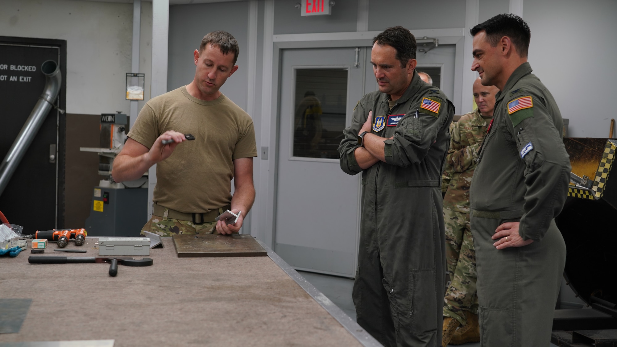 Master Sgt. explains how to perform the job task of installing a nutplate on a piece of extrusion.