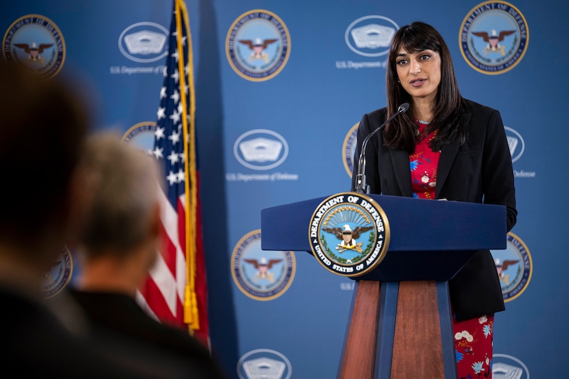 A woman speaks from a podium.